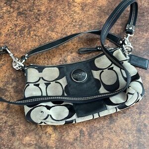 Coach cross body purse, black with tan, gently used, some wear.